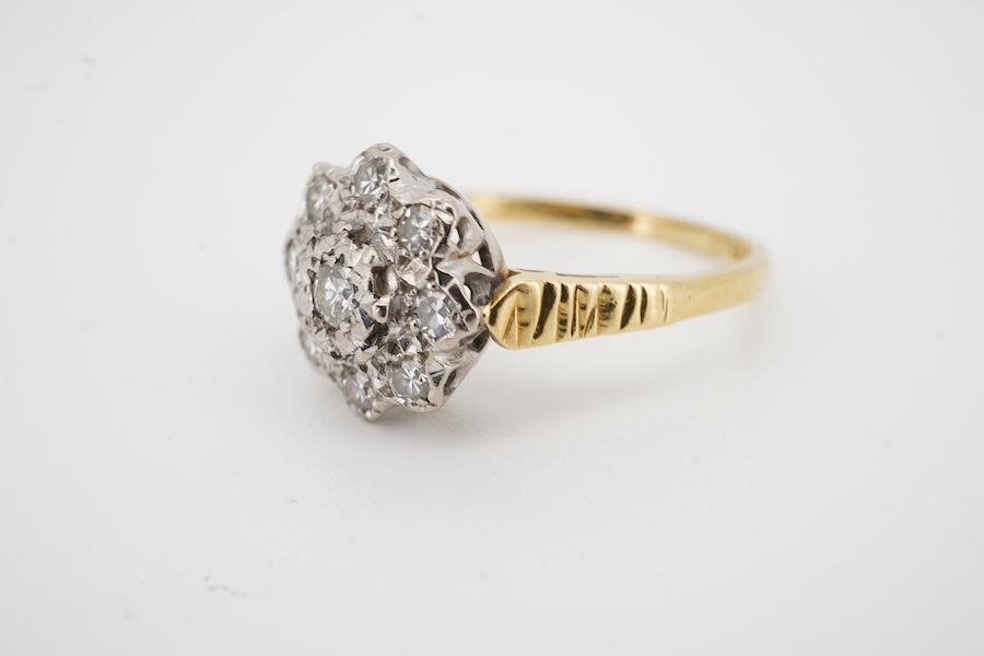 An 18ct and illusion set diamond cluster ring, size M/N, gross weight 3.6 grams. Condition - fair